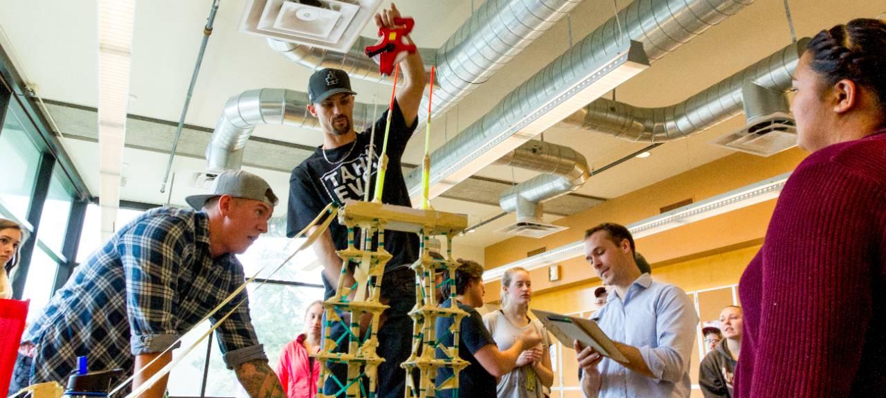 A group of students build a tower  